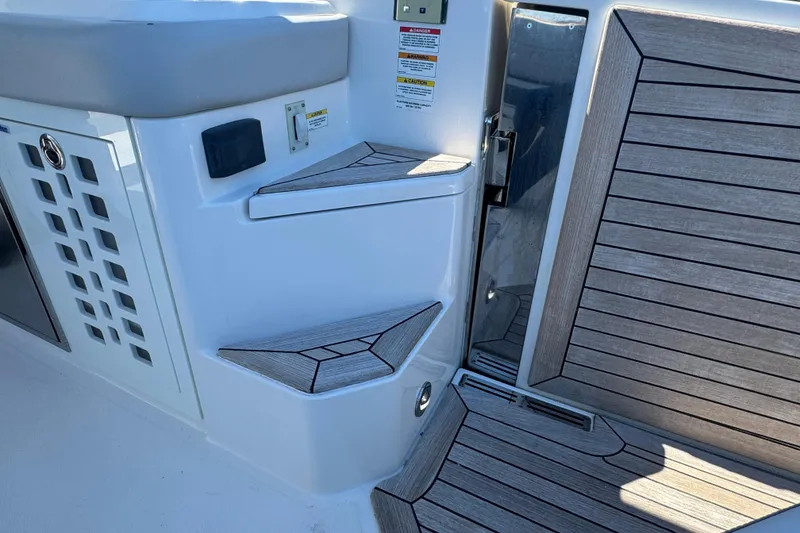 Slide: The Image of 2022 Sea Ray SLX 400 Outboard boat steps and deck with wood finish. - 30
