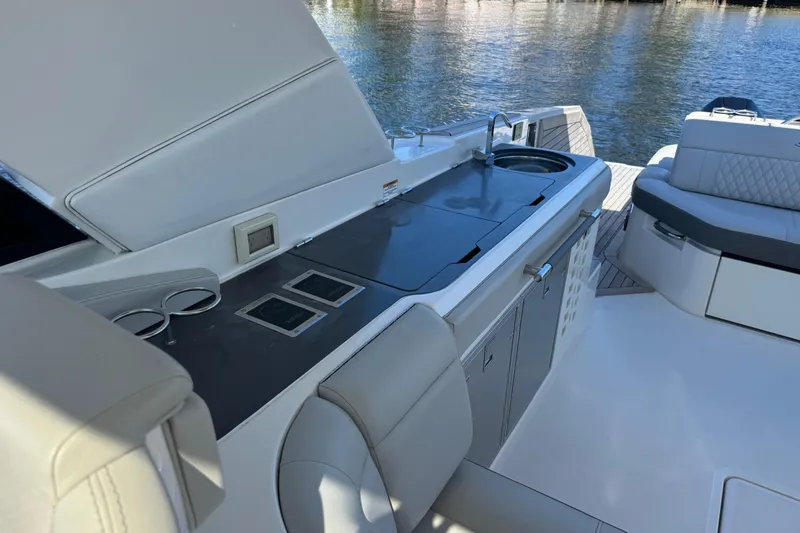 Slide: The Image of 2022 Sea Ray SLX 400 Outboard boat interior with sleek kitchen and seating area. - 31