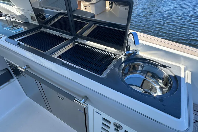 Slide: The Image of Outdoor kitchen on 2022 Sea Ray SLX 400 Outboard yacht with grill and sink. - 33