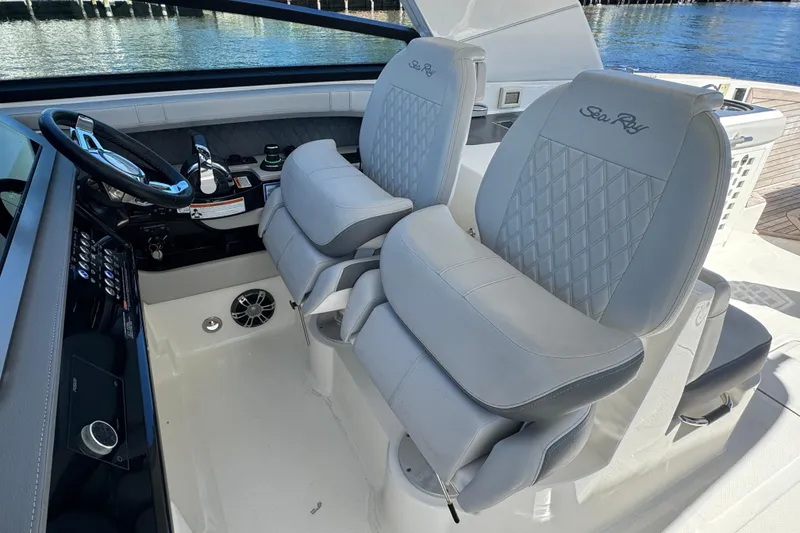 Slide: The Image of 2022 Sea Ray SLX 400 Outboard cockpit with luxurious seating and modern controls. - 40