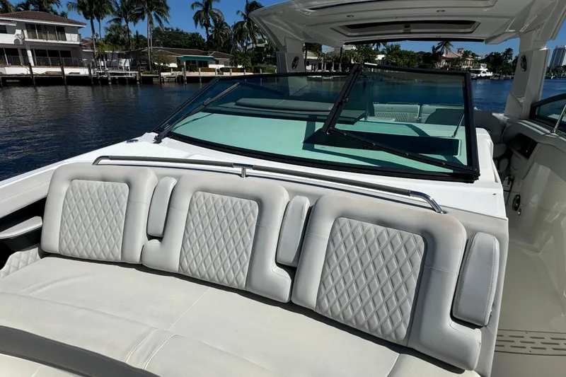 Slide: The Image of 2022 Sea Ray SLX 400 Outboard with luxurious seating, docked by waterfront homes. - 43