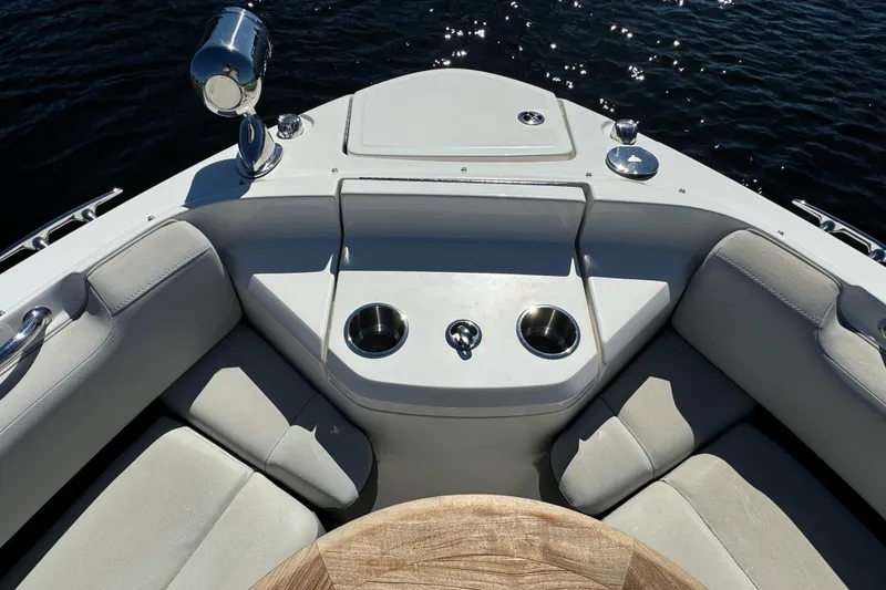 Slide: The Image of Bow seating area of 2022 Sea Ray SLX 400 Outboard with cup holders and table. - 48