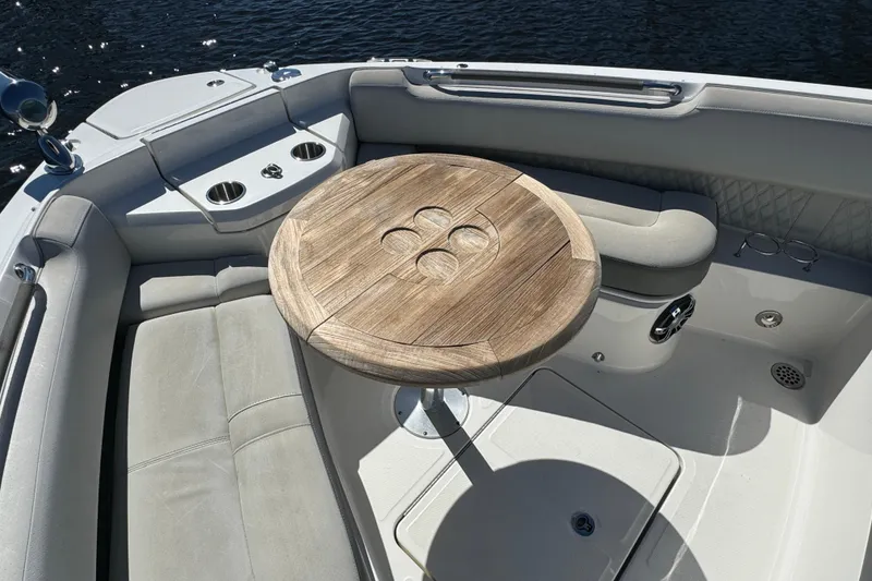 Slide: The Image of Luxurious seating area on 2022 Sea Ray SLX 400 Outboard with wooden table. - 49