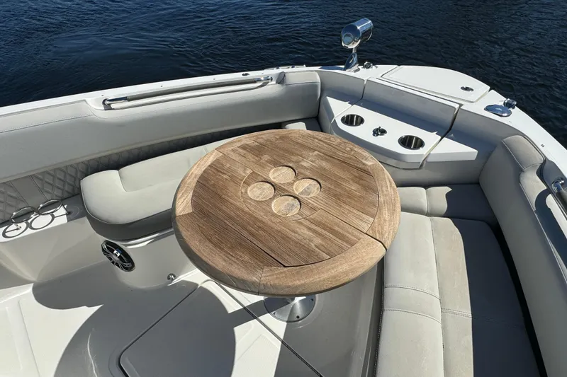 Slide: The Image of Luxurious seating area on 2022 Sea Ray SLX 400 Outboard boat with wooden table. - 51