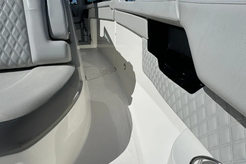 Slide: The Image of 2022 Sea Ray SLX 400 Outboard interior with luxurious seating and quilted upholstery. - 53