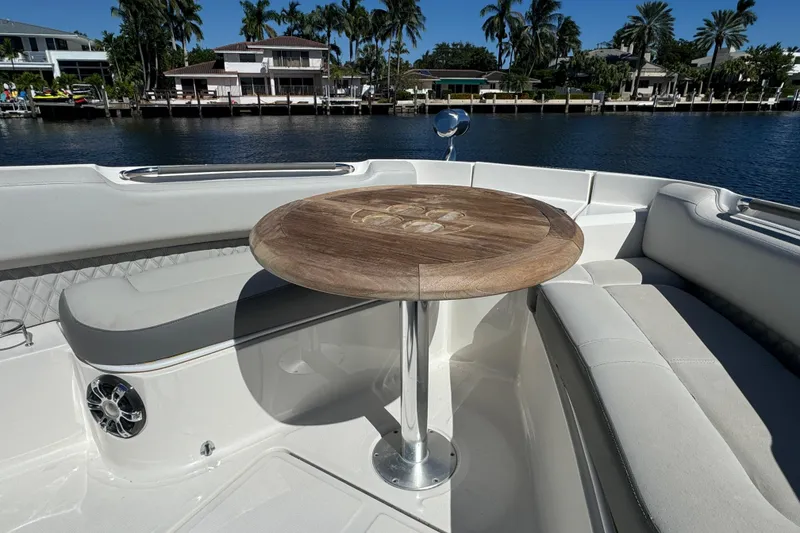 Slide: The Image of Luxurious seating area on 2022 Sea Ray SLX 400 Outboard boat with wooden table. - 55