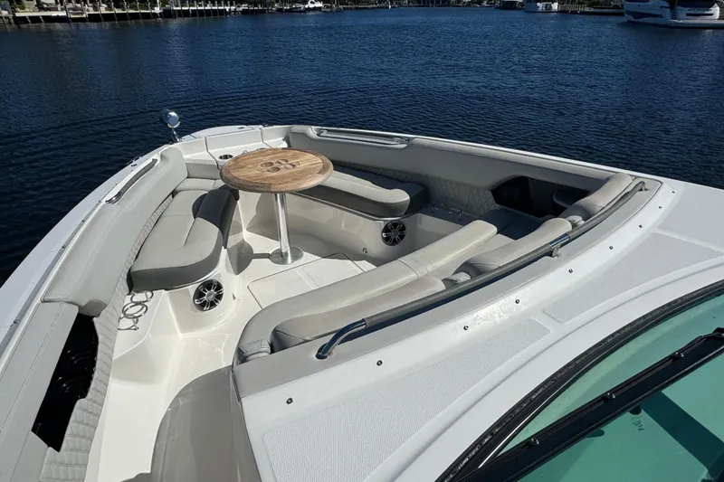 Slide: The Image of 2022 Sea Ray SLX 400 Outboard boat with spacious seating and table on calm water. - 56