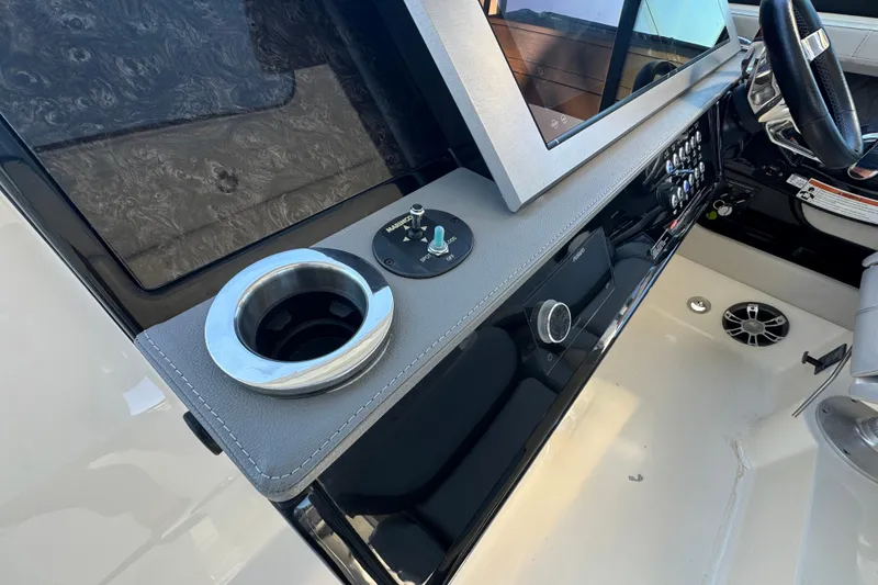Slide: The Image of 2022 Sea Ray SLX 400 Outboard helm with modern controls and cup holder. - 57