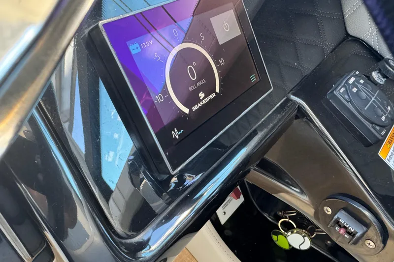 Slide: The Image of 2022 Sea Ray SLX 400 Outboard dashboard with digital display and controls. - 60