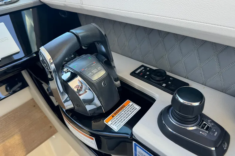 Slide: The Image of Control panel of 2022 Sea Ray SLX 400 Outboard with joystick and throttle. - 62