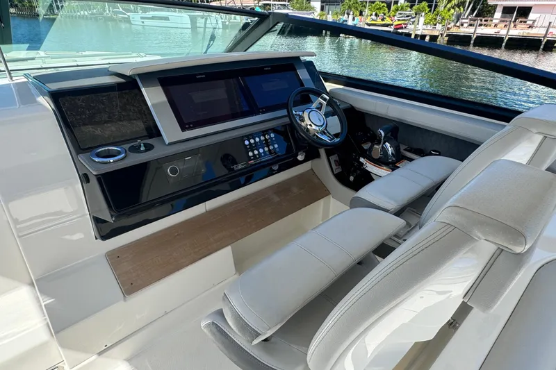 Slide: The Image of 2022 Sea Ray SLX 400 Outboard helm with modern controls and luxurious seating. - 7