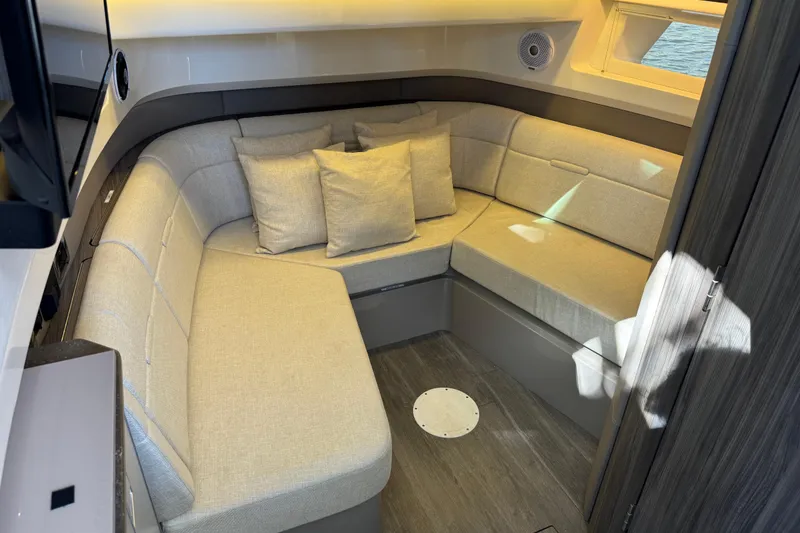 Slide: The Image of 2022 Sea Ray SLX 400 Outboard cabin with cozy seating and modern interior design. - 70