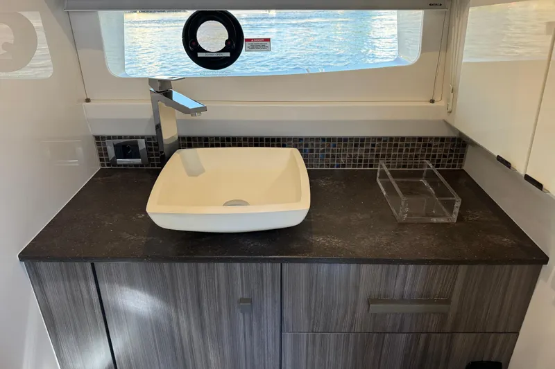 Slide: The Image of Modern bathroom sink in 2022 Sea Ray SLX 400 Outboard yacht interior. - 73