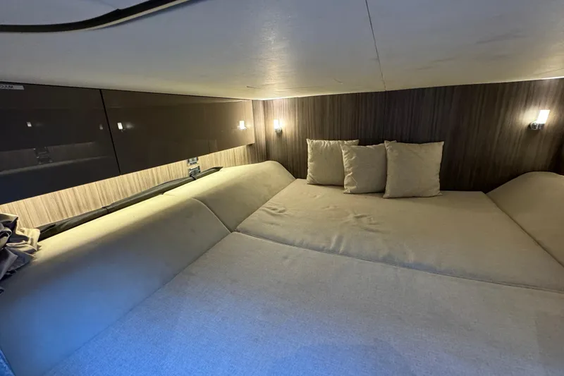 Slide: The Image of Interior cabin of 2022 Sea Ray SLX 400 Outboard, featuring cozy bedding and ambient lighting. - 76