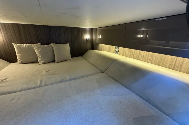 Slide: The Image of Interior cabin of 2022 Sea Ray SLX 400 Outboard with cozy bedding and ambient lighting. - 77