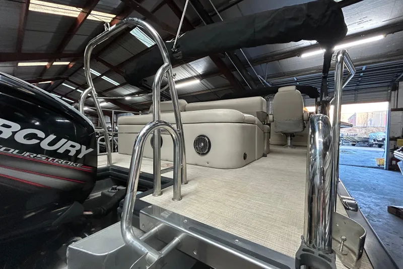 Slide: The Image of 2019 Harris CRUIZER 230 Salt Edition pontoon boat interior with beige seating and black canopy. - 27