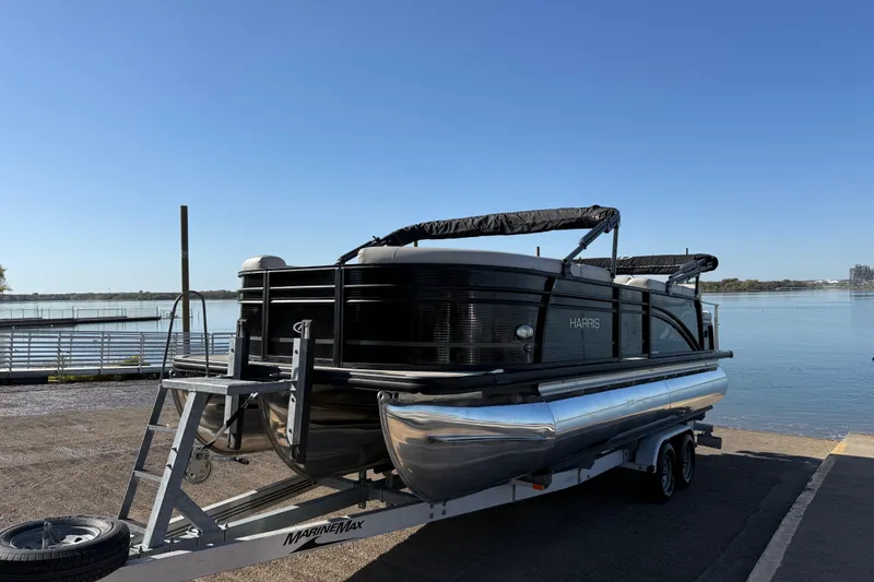 Slide: The Image of 2019 Harris CRUIZER 230 SALT EDITION pontoon boat on trailer by waterfront. - 44