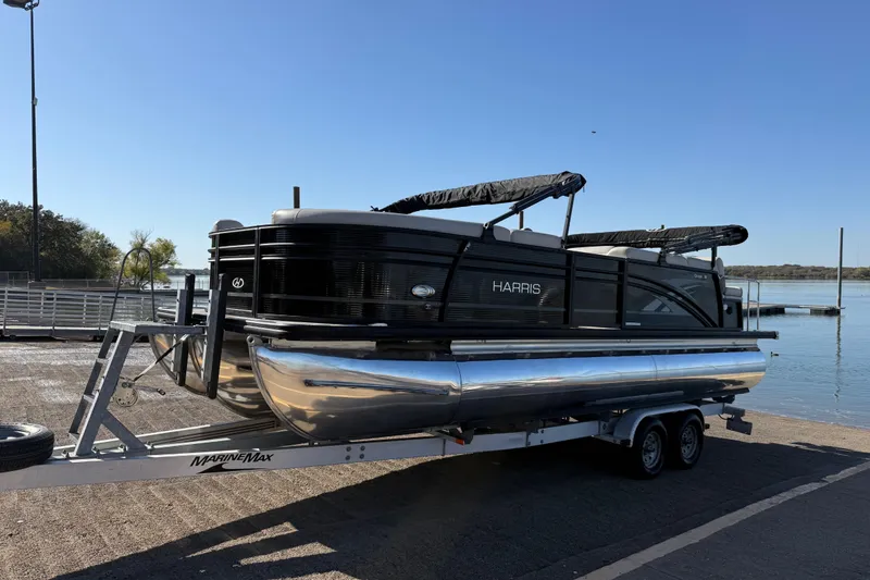 Slide: The Image of 2019 Harris CRUIZER 230 SALT EDITION pontoon boat on trailer by the water. - 45