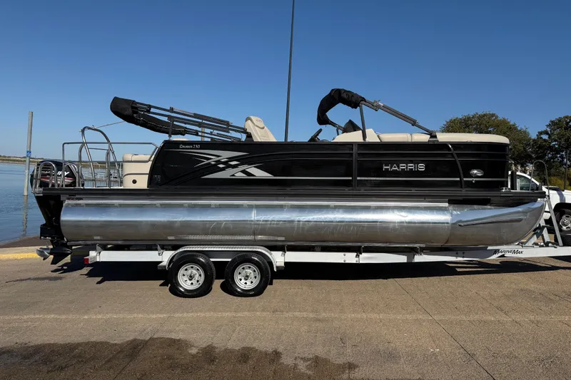 Slide: The Image of 2019 Harris CRUIZER 230 SALT EDITION pontoon boat on trailer by the water. - 57