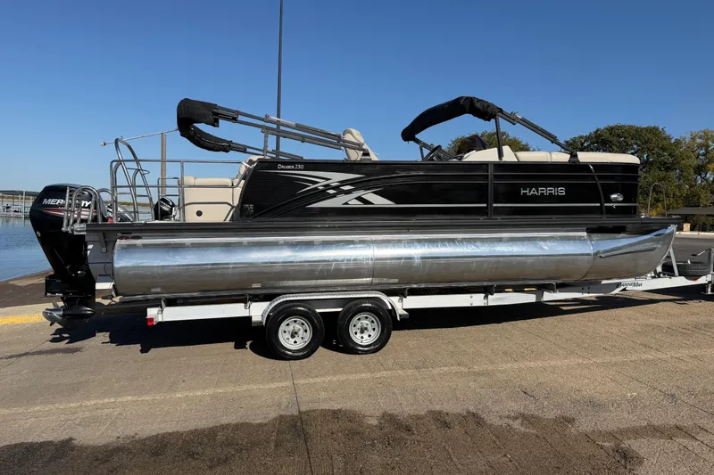 Slide: The Image of 2019 Harris CRUIZER 230 SALT EDITION pontoon boat on trailer, dockside view. - 58