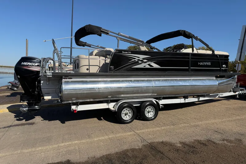 Slide: The Image of 2019 Harris CRUIZER 230 SALT EDITION pontoon boat on trailer, featuring a Mercury outboard motor. - 59
