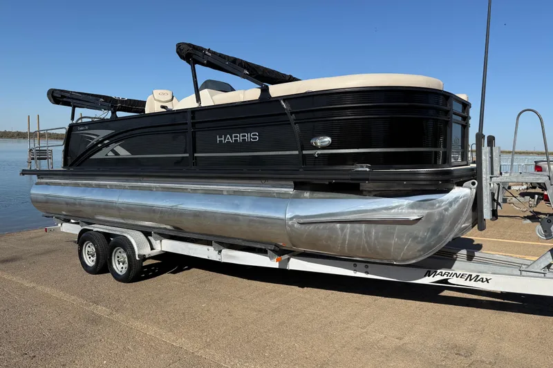 Slide: The Image of 2019 Harris CRUIZER 230 SALT EDITION pontoon boat on trailer by the water. - 60