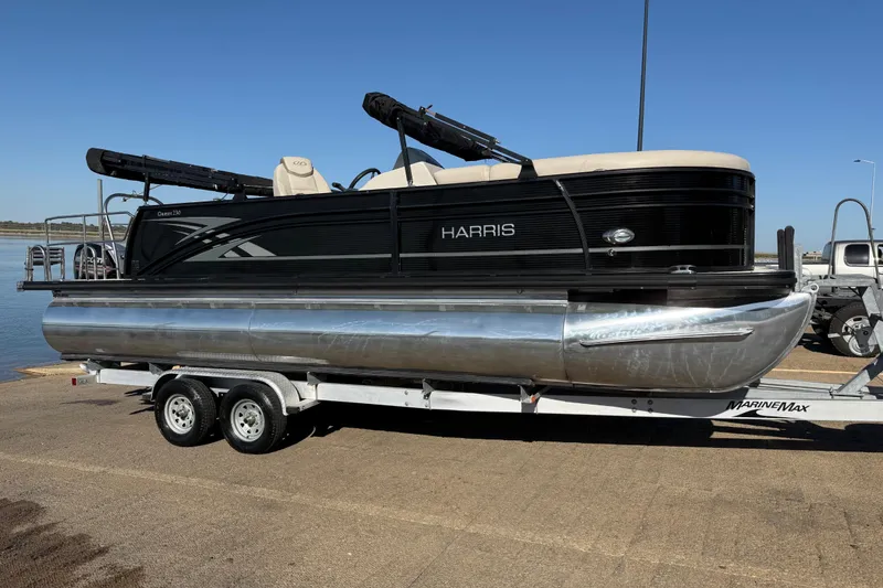 Slide: The Image of 2019 Harris CRUIZER 230 SALT EDITION pontoon boat on trailer by the water. - 61