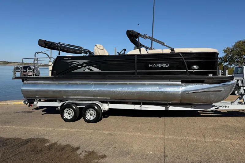 Slide: The Image of 2019 Harris CRUIZER 230 SALT EDITION pontoon boat on trailer by the water. - 62