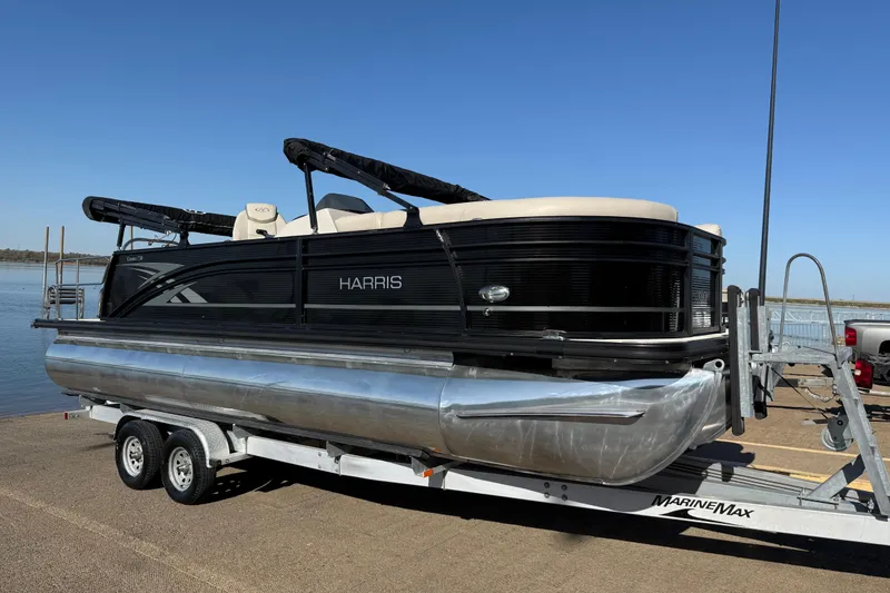Slide: The Image of 2019 Harris CRUIZER 230 SALT EDITION pontoon boat on trailer by the water. - 65