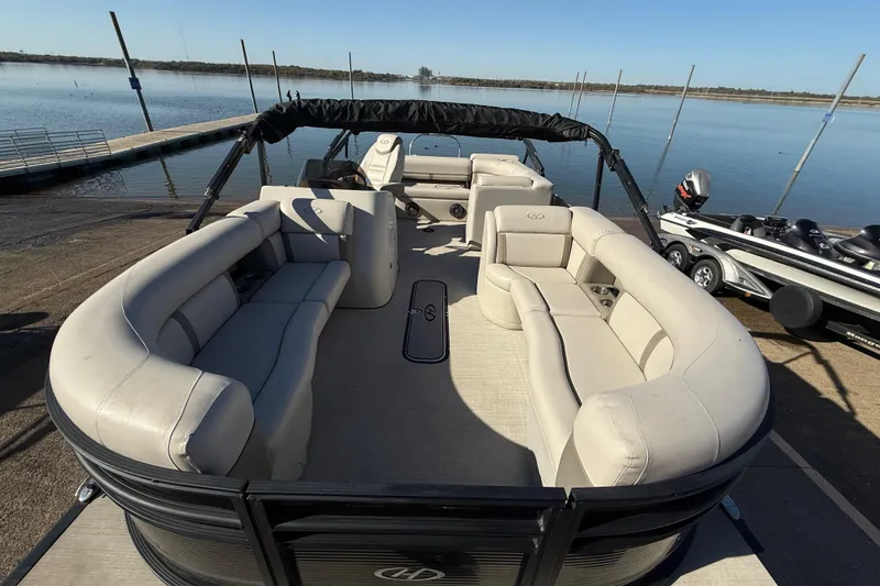 Slide: The Image of 2019 Harris CRUIZER 230 SALT EDITION pontoon boat with spacious seating at a dock. - 70