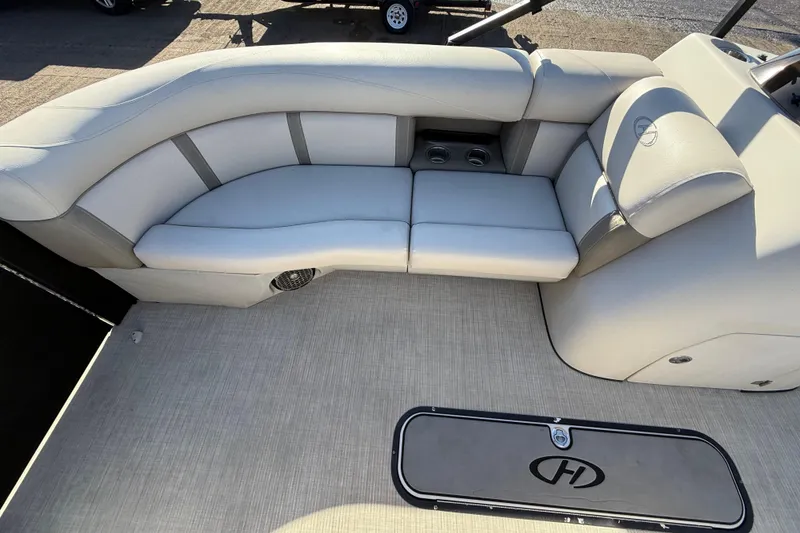 Slide: The Image of 2019 Harris CRUIZER 230 SALT EDITION boat interior with cushioned seating and storage. - 72