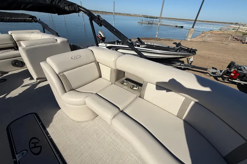 Slide: The Image of 2019 Harris CRUIZER 230 SALT EDITION boat interior with beige seating and cup holders. - 73