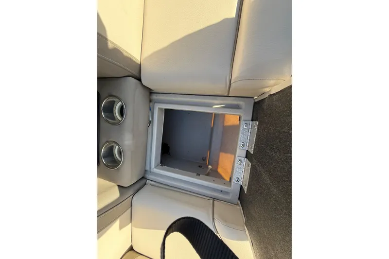 Slide: The Image of Open storage compartment on 2019 Harris CRUIZER 230 SALT EDITION boat with cup holders. - 75