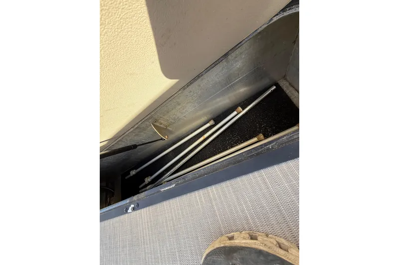 Slide: The Image of Storage compartment of 2019 Harris CRUIZER 230 SALT EDITION with metal rods inside. - 78