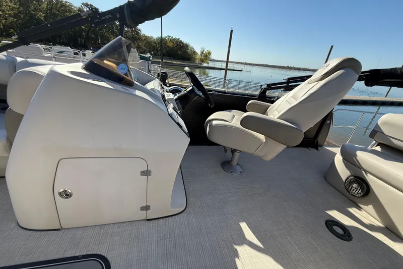 Slide: The Image of 2019 Harris CRUIZER 230 SALT EDITION boat interior with captain's chair and control panel. - 79