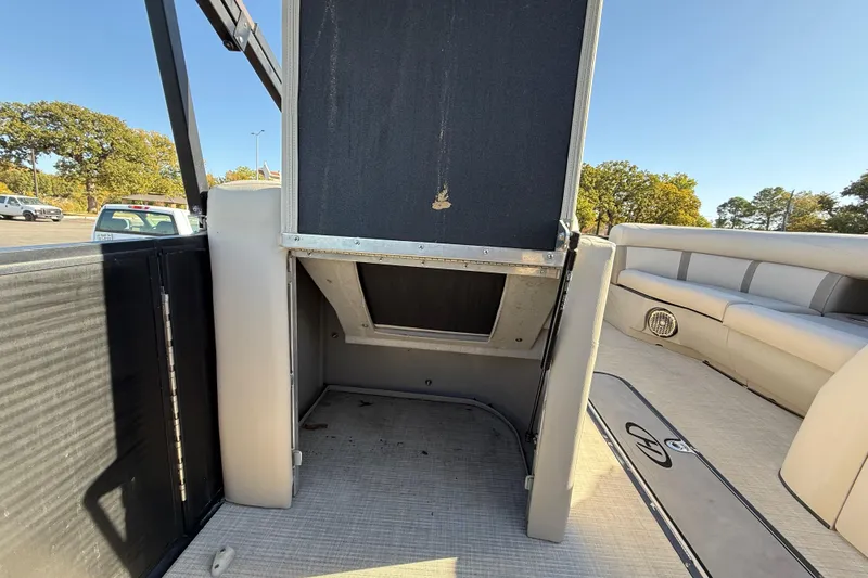 Slide: The Image of 2019 Harris CRUIZER 230 SALT EDITION boat interior with storage compartment open. - 81