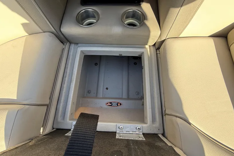 Slide: The Image of 2019 Harris CRUIZER 230 SALT EDITION storage compartment with cup holders and beige seating. - 83