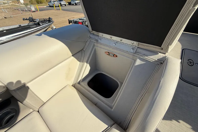 Slide: The Image of 2019 Harris CRUIZER 230 SALT EDITION boat interior with open storage compartment. - 84