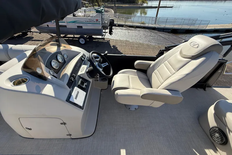 Slide: The Image of 2019 Harris CRUIZER 230 Salt Edition boat helm with steering wheel and captain's chair. - 86