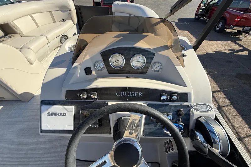 Slide: The Image of 2019 Harris CRUIZER 230 Salt Edition boat dashboard with steering wheel and gauges. - 89