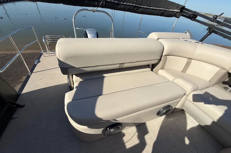 Slide: The Image of 2019 Harris CRUIZER 230 SALT EDITION boat with beige seating and lake view. - 91