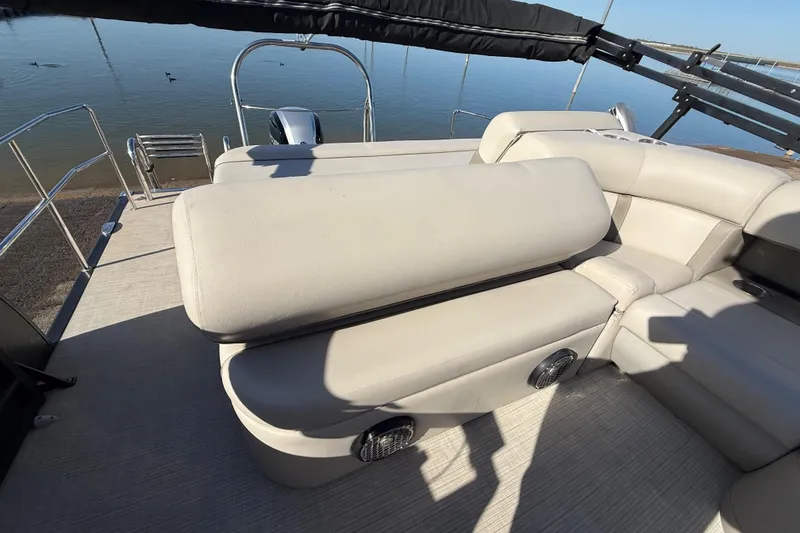 Slide: The Image of 2019 Harris CRUIZER 230 SALT EDITION boat interior with beige seating and water view. - 92