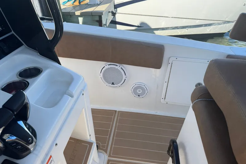 Slide: The Image of 2022 Sea Hunt Ultra 305 SE boat interior with seating and control panel. - 13