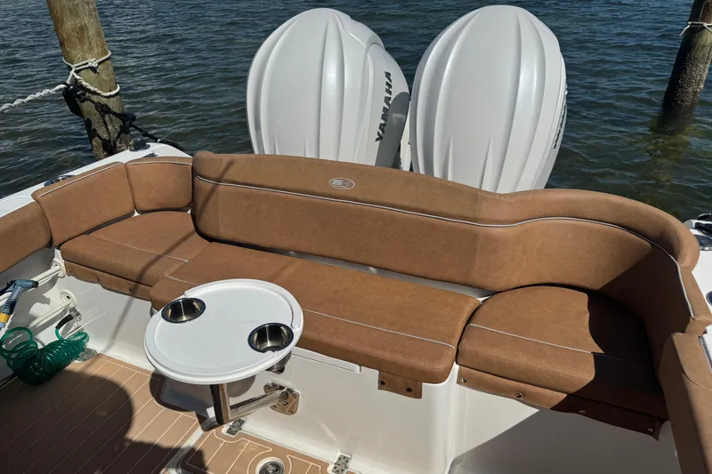 Slide: The Image of 2022 Sea Hunt Ultra 305 SE boat with brown seating and dual Yamaha engines. - 15