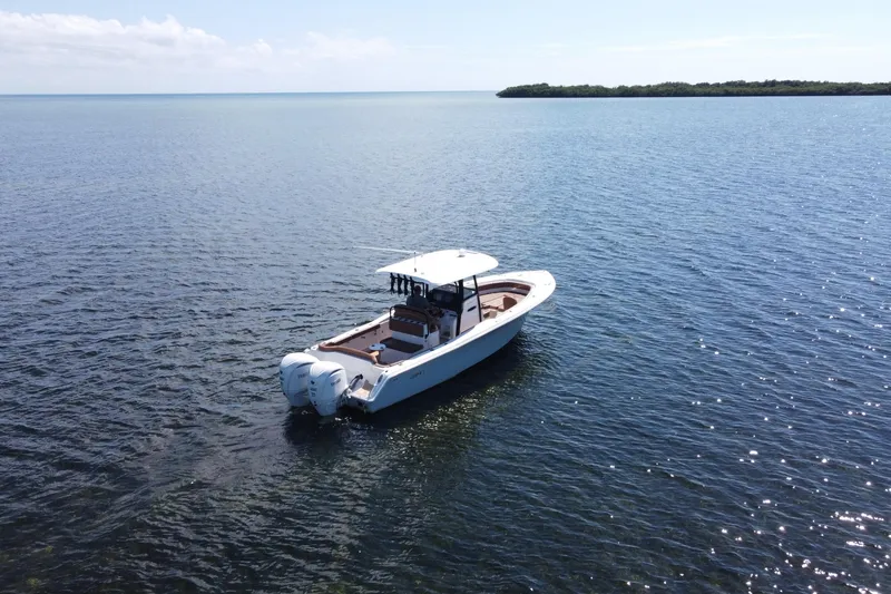 Slide: The Image of 2022 Sea Hunt Ultra 305 SE boat on calm ocean waters. - 2