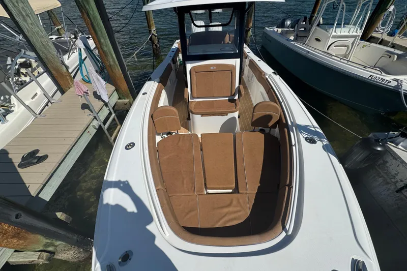 Slide: The Image of 2022 Sea Hunt Ultra 305 SE boat docked, featuring spacious seating and sleek design. - 29