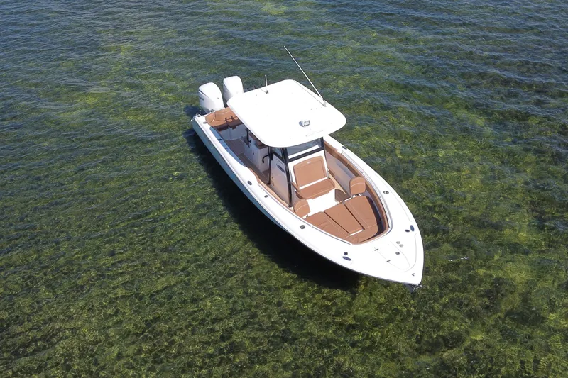 Slide: The Image of 2022 Sea Hunt Ultra 305 SE boat on clear green water, aerial view. - 4