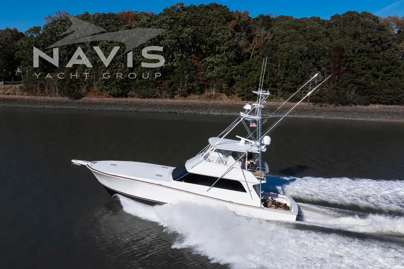 Slide: The Image of 1998 Viking 58 Convertible yacht cruising on calm waters, Navis Yacht Group branding visible. - 10