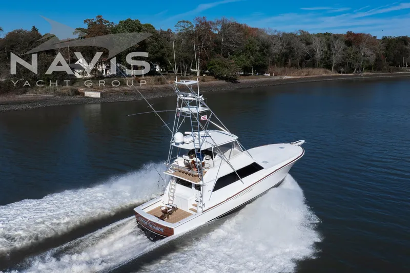 Slide: The Image of 1998 Viking 58 Convertible yacht deck with fishing chair, Navis Yacht Group branding. - 16