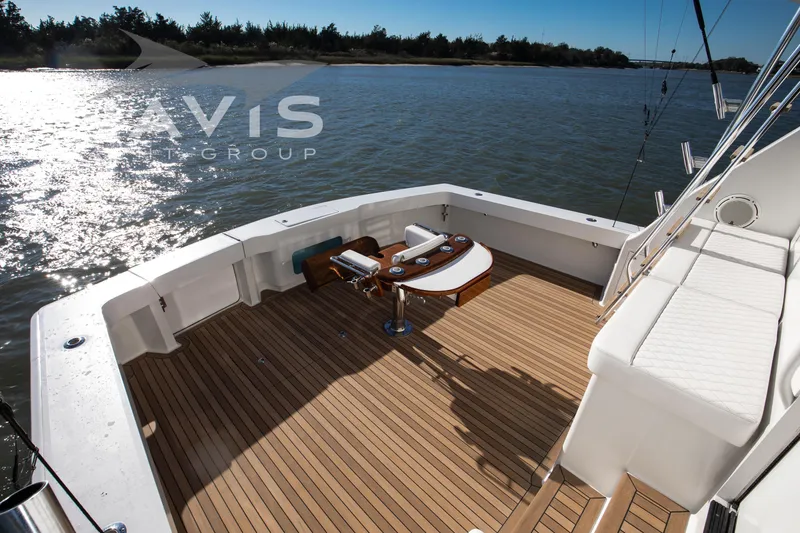 Slide: The Image of Luxurious interior of 1998 Viking 58 Convertible yacht with modern furnishings and scenic view. - 25